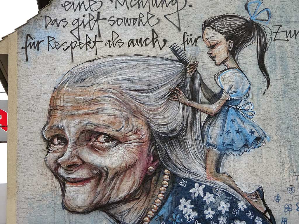 Geben geht nicht nur in eine Richtung - Mural von Herakut in Bad Vilbel