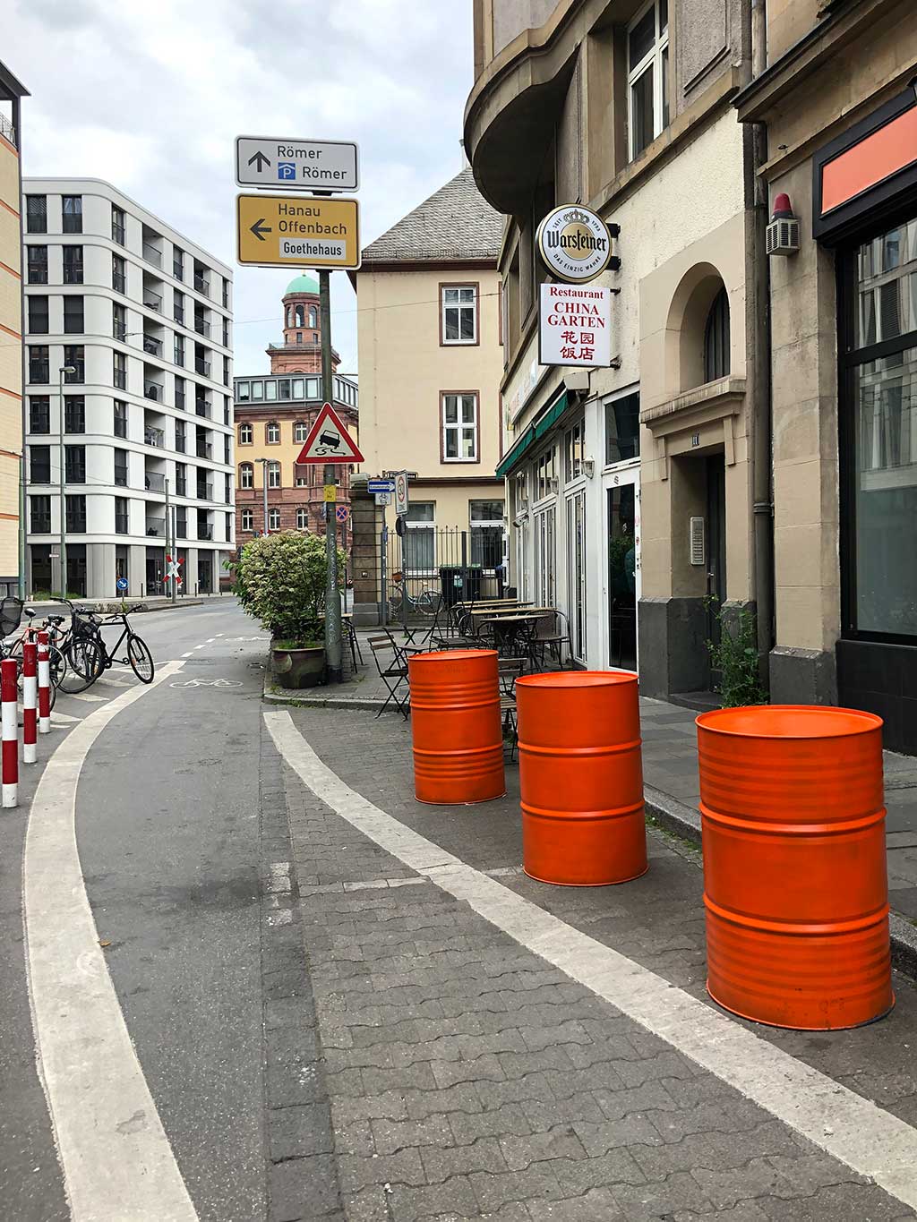 Drei Orange farbene Tonnen auf der Straße in Frankfurt