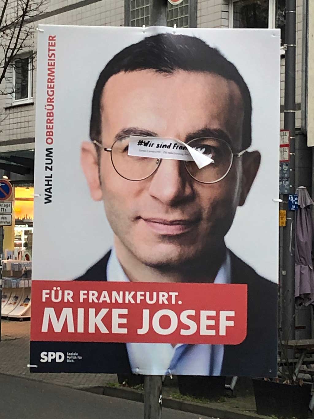 Mit „Wir sind Frankfurt“ überklebte Wahlplakate in Frankfurt